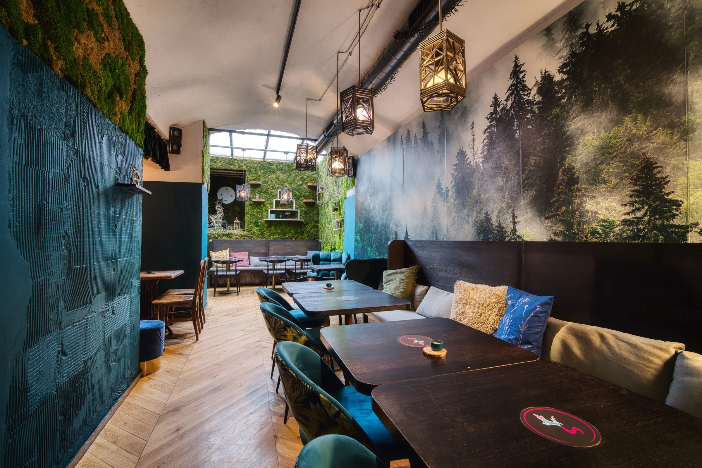 Tables along the forest mural in the main room