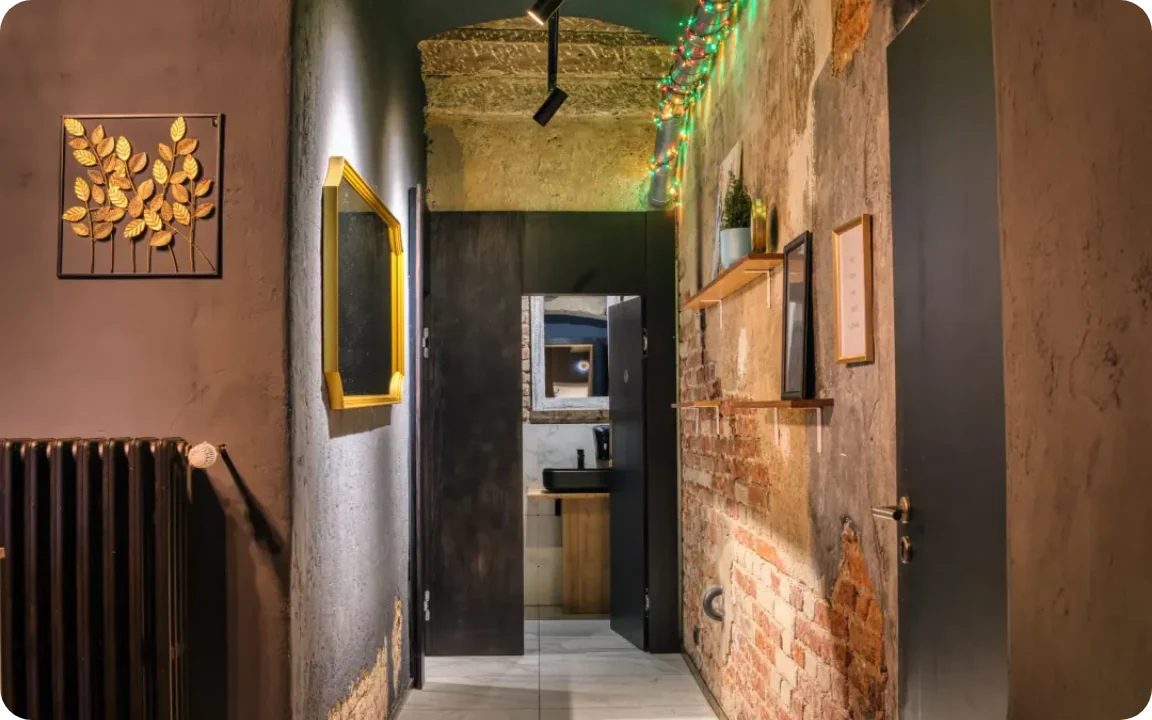 Hallway with brick wall and framed art